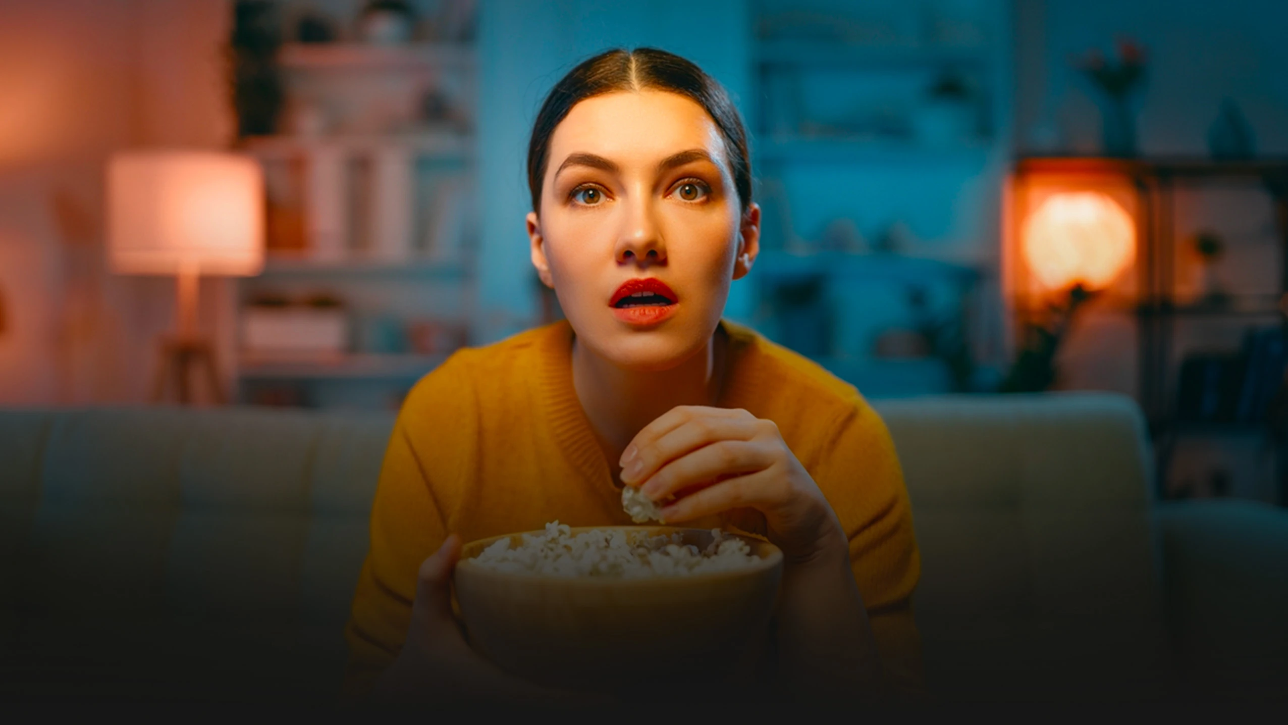 Woman enjoying IPTV with popcorn